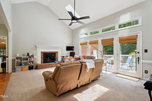 5405 Doemont Dr, Apex, NC 27539 - carpeted living room with high vaulted ceiling, a brick fireplace, and ceiling fan