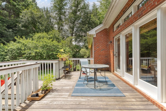 5405 Doemont Dr, Apex, NC 27539 - wooden terrace featuring view of scattered trees and outdoor dining space