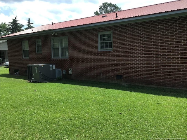 108 Thurlow St, Red Springs, NC 28377 - back of property featuring a metal roof, a yard, and brick siding