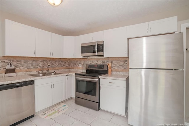 6310 Glenlea Cir, Fayetteville, NC 28314 - kitchen featuring stainless steel appliances, white cabinetry, and light tile patterned floors
