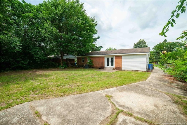 6310 Glenlea Cir, Fayetteville, NC 28314 - back of property with entry steps, french doors, a yard, and concrete driveway