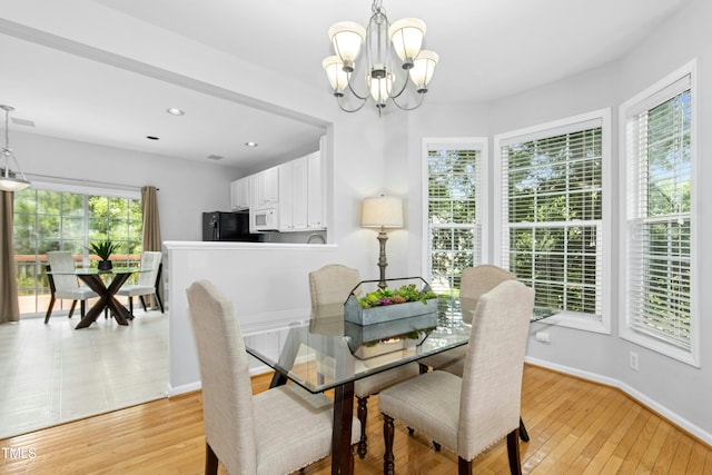 5545 Crabtree Park Ct, Raleigh, NC 27612 - dining room with a chandelier and light wood-type flooring