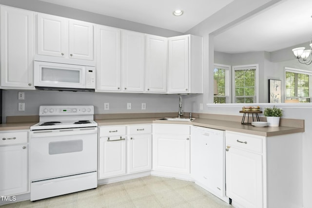 5545 Crabtree Park Ct, Raleigh, NC 27612 - kitchen with white appliances, white cabinetry, a chandelier, a peninsula, and recessed lighting