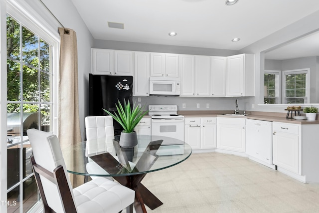 5545 Crabtree Park Ct, Raleigh, NC 27612 - kitchen with white appliances, light floors, white cabinetry, and recessed lighting