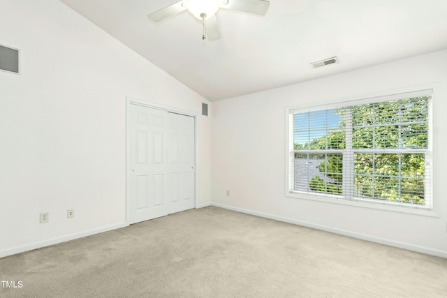 5545 Crabtree Park Ct, Raleigh, NC 27612 - unfurnished bedroom featuring light colored carpet, vaulted ceiling, ceiling fan, and a closet