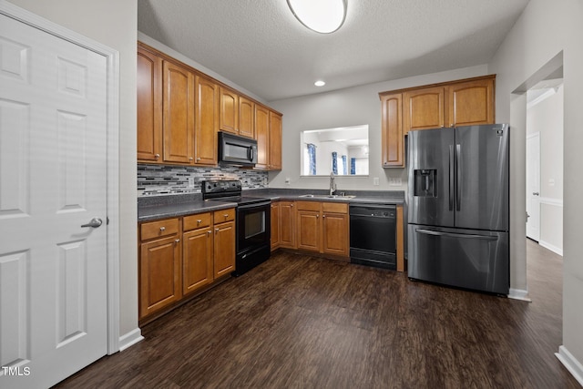 3408 Sosa Rd, Raleigh, NC 27610 - kitchen featuring black appliances, dark countertops, dark wood-style flooring, brown cabinets, and recessed lighting