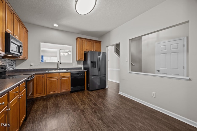 3408 Sosa Rd, Raleigh, NC 27610 - kitchen with black appliances, dark countertops, dark wood finished floors, a textured ceiling, and brown cabinetry
