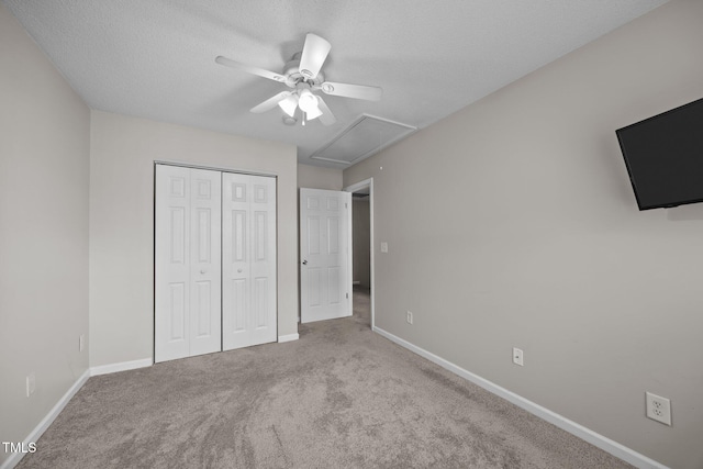 3408 Sosa Rd, Raleigh, NC 27610 - unfurnished bedroom featuring carpet, a textured ceiling, a closet, attic access, and ceiling fan