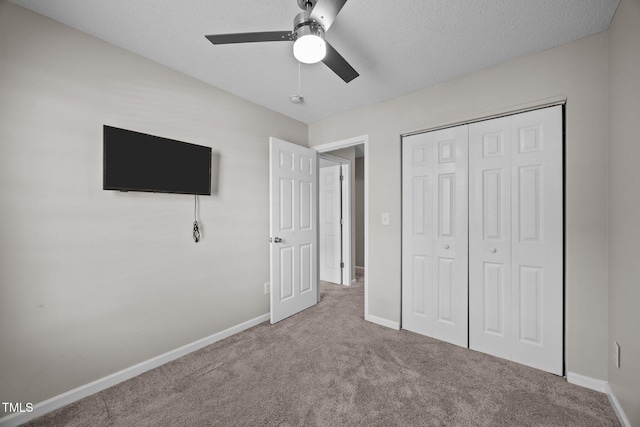 3408 Sosa Rd, Raleigh, NC 27610 - unfurnished bedroom featuring carpet, a closet, a textured ceiling, and a ceiling fan