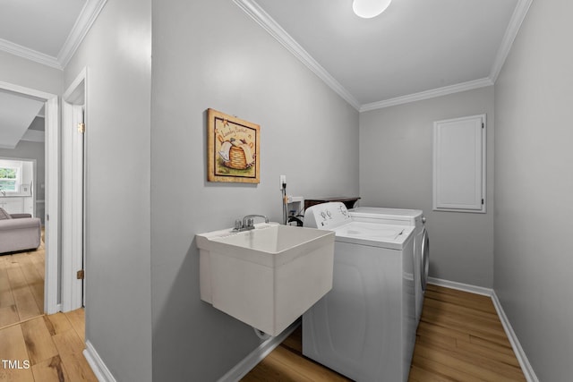 541 Mallie Pearce Rd, Zebulon, NC 27597 - laundry area with washer and clothes dryer, ornamental molding, and light wood-type flooring