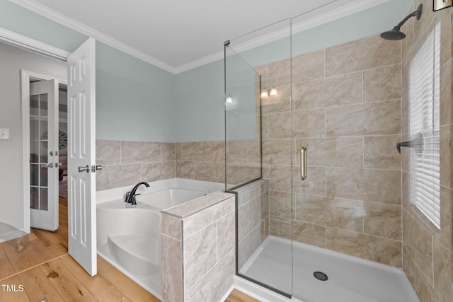 541 Mallie Pearce Rd, Zebulon, NC 27597 - bathroom featuring a garden tub, crown molding, a shower stall, and wood finished floors