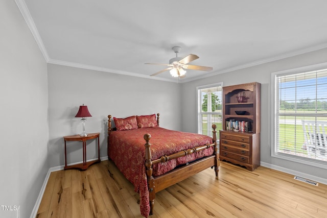 541 Mallie Pearce Rd, Zebulon, NC 27597 - bedroom featuring ornamental molding, light wood-type flooring, and a ceiling fan
