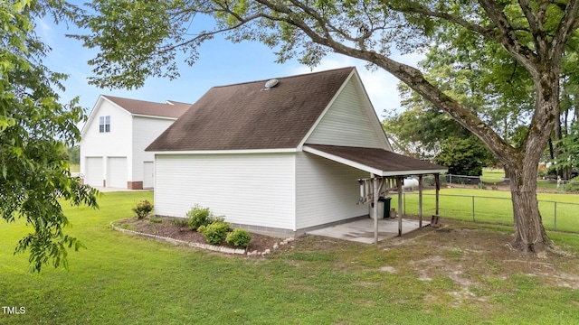 541 Mallie Pearce Rd, Zebulon, NC 27597 - view of property exterior featuring a shingled roof, a patio, and a detached garage