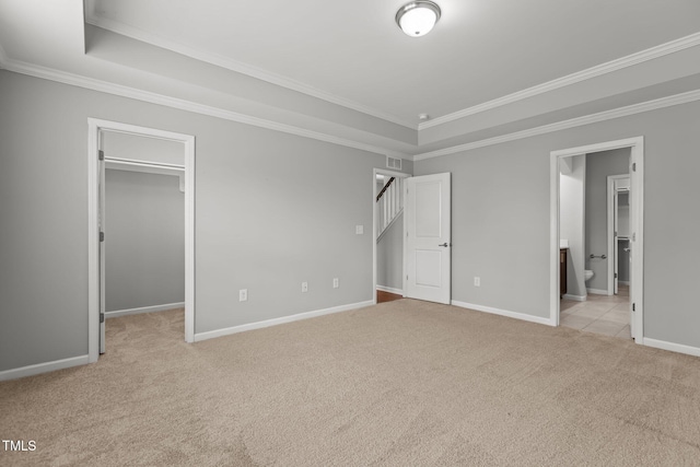 1172 Pemberly Ave, Morrisville, NC 27560 - unfurnished bedroom with carpet flooring, a walk in closet, ornamental molding, ensuite bathroom, and a tray ceiling