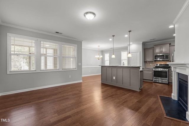 1172 Pemberly Ave, Morrisville, NC 27560 - kitchen featuring stainless steel appliances, crown molding, a chandelier, gray cabinetry, and tasteful backsplash