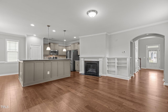 1172 Pemberly Ave, Morrisville, NC 27560 - unfurnished living room with crown molding, arched walkways, recessed lighting, dark wood finished floors, and healthy amount of natural light
