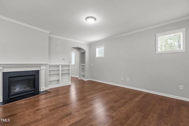 1172 Pemberly Ave, Morrisville, NC 27560 - unfurnished living room featuring arched walkways, healthy amount of natural light, crown molding, dark wood-style floors, and a fireplace
