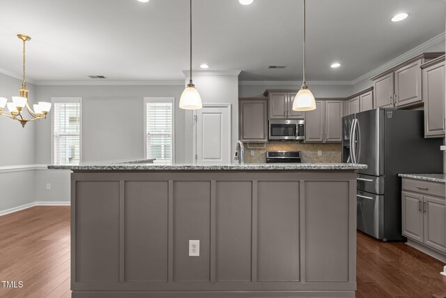 1172 Pemberly Ave, Morrisville, NC 27560 - kitchen with stainless steel appliances, gray cabinetry, a chandelier, backsplash, and dark wood finished floors