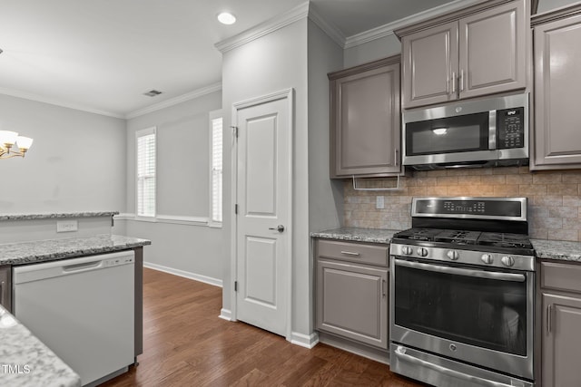 1172 Pemberly Ave, Morrisville, NC 27560 - kitchen with stainless steel appliances, gray cabinetry, backsplash, crown molding, and dark wood-type flooring