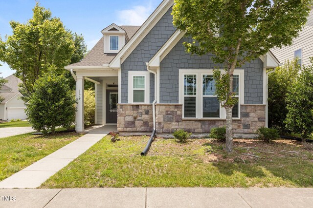 1172 Pemberly Ave, Morrisville, NC 27560 - craftsman inspired home with stone siding, a front yard, and roof with shingles