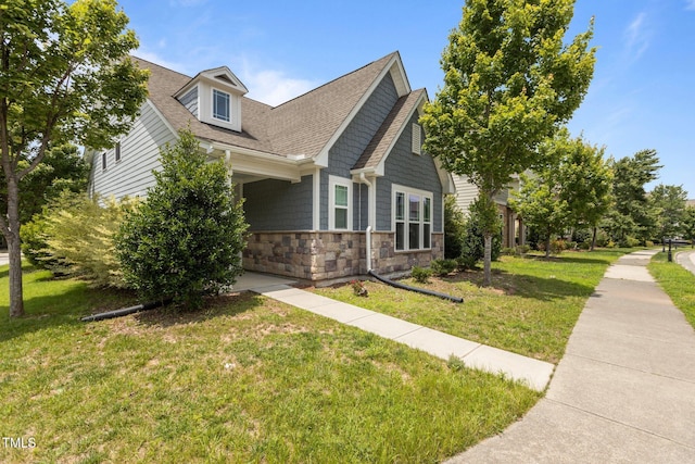 1172 Pemberly Ave, Morrisville, NC 27560 - view of side of property featuring stone siding, a lawn, and roof with shingles