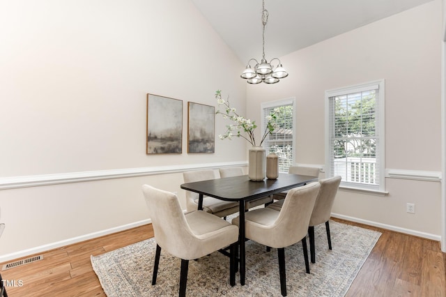 202 Chapel Valley Ln, Apex, NC 27502 - dining space featuring a chandelier, wood finished floors, and high vaulted ceiling