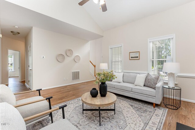 202 Chapel Valley Ln, Apex, NC 27502 - living area with plenty of natural light, stairway, wood finished floors, and lofted ceiling