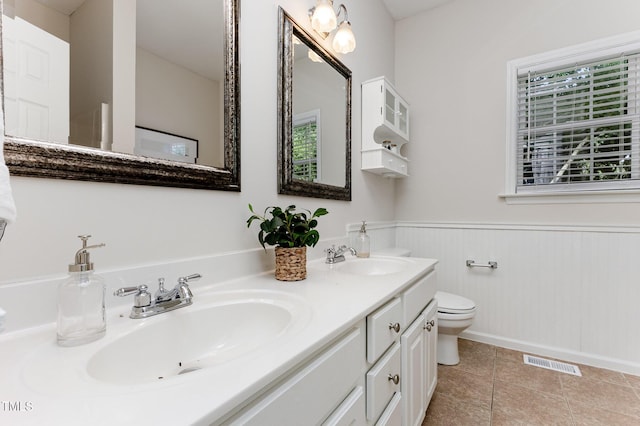 202 Chapel Valley Ln, Apex, NC 27502 - full bath featuring double vanity, wainscoting, and tile patterned flooring