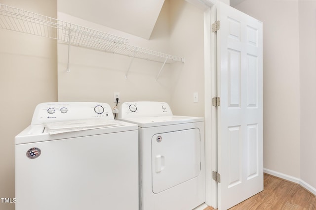 202 Chapel Valley Ln, Apex, NC 27502 - laundry room with light wood-type flooring and separate washer and dryer
