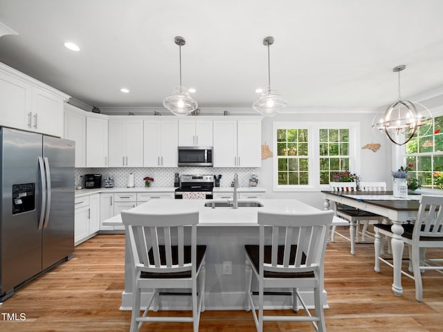 1176 Sagamore Dr, Louisburg, NC 27549 - kitchen with stainless steel appliances, light countertops, decorative backsplash, light wood-style flooring, and recessed lighting
