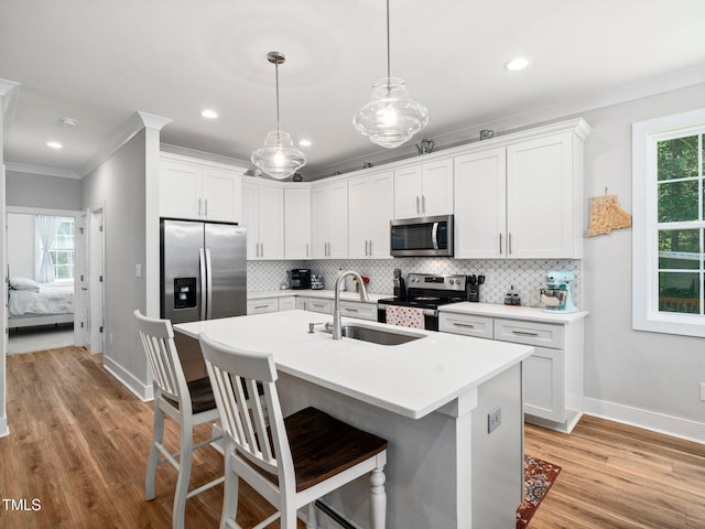 1176 Sagamore Dr, Louisburg, NC 27549 - kitchen featuring stainless steel appliances, crown molding, plenty of natural light, a breakfast bar, and decorative backsplash