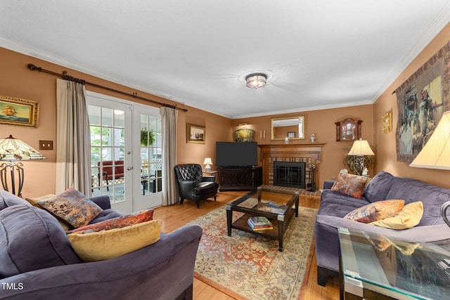 116 Lost Tree Ln, Cary, NC 27513 - living room featuring ornamental molding, light wood-style floors, a fireplace, and french doors