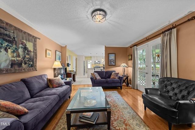 116 Lost Tree Ln, Cary, NC 27513 - living room with light wood finished floors, crown molding, french doors, and a textured ceiling
