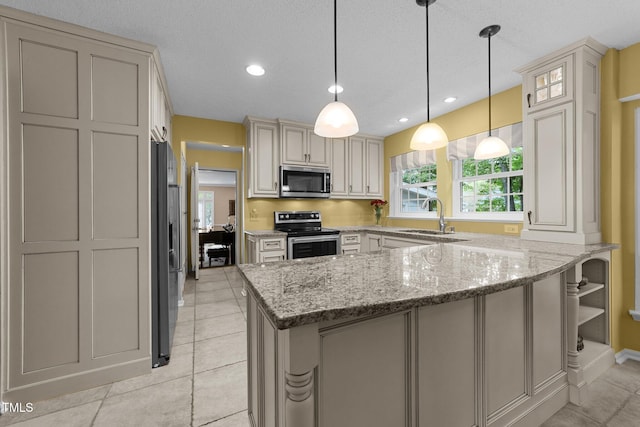 116 Lost Tree Ln, Cary, NC 27513 - kitchen with appliances with stainless steel finishes, a peninsula, light stone countertops, hanging light fixtures, and a textured ceiling