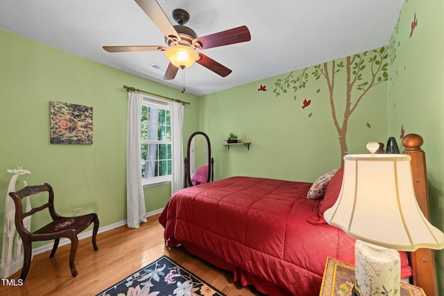 116 Lost Tree Ln, Cary, NC 27513 - bedroom with wood finished floors, a textured ceiling, and ceiling fan