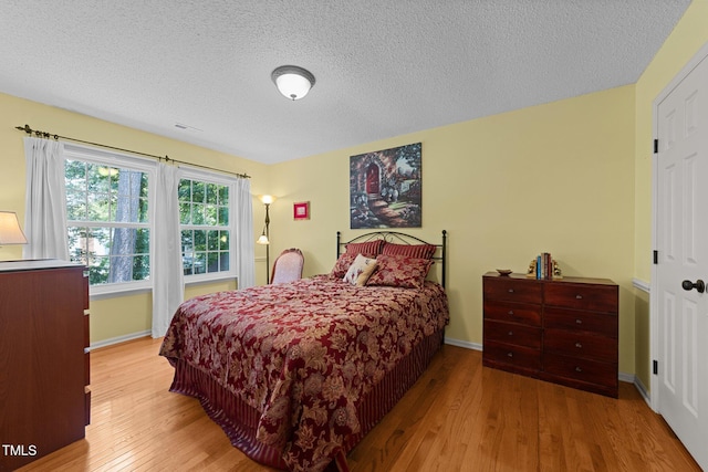 116 Lost Tree Ln, Cary, NC 27513 - bedroom with wood finished floors and a textured ceiling