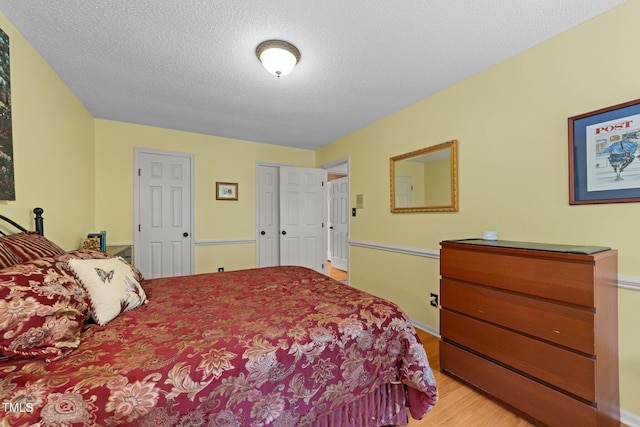 116 Lost Tree Ln, Cary, NC 27513 - bedroom with light wood-type flooring and a textured ceiling
