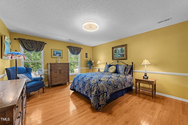 116 Lost Tree Ln, Cary, NC 27513 - bedroom featuring a textured ceiling and wood finished floors