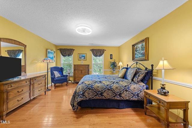 116 Lost Tree Ln, Cary, NC 27513 - bedroom featuring light wood-style floors and a textured ceiling
