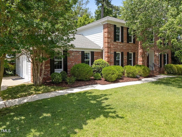 116 Lost Tree Ln, Cary, NC 27513 - view of front facade featuring brick siding, a front yard, a shingled roof, and driveway