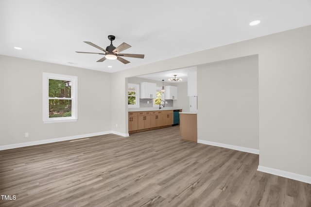 1605 Nixon St, Durham, NC 27707 - unfurnished living room featuring light wood-style floors, ceiling fan, a chandelier, plenty of natural light, and recessed lighting
