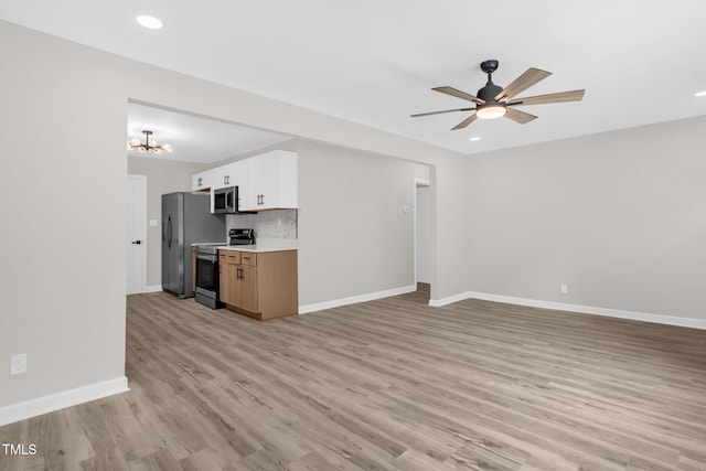 1605 Nixon St, Durham, NC 27707 - unfurnished living room featuring light wood-type flooring, ceiling fan, a chandelier, and recessed lighting