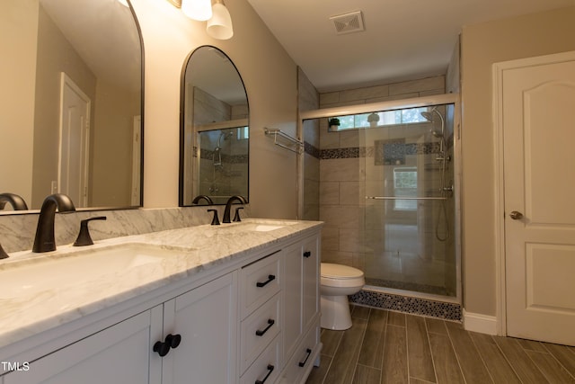 5200 Fieldwood Ct, Raleigh, NC 27616 - bathroom featuring a shower stall, double vanity, and wood tiled floors