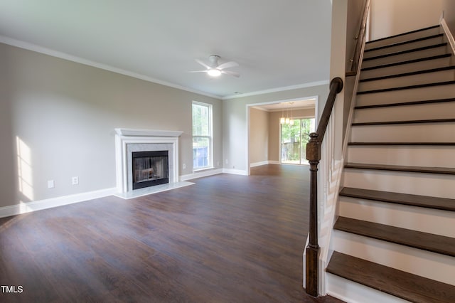 5200 Fieldwood Ct, Raleigh, NC 27616 - unfurnished living room with stairway, dark wood-style floors, crown molding, a ceiling fan, and a high end fireplace