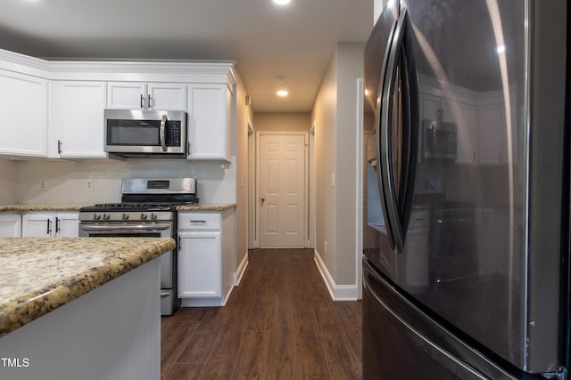 5200 Fieldwood Ct, Raleigh, NC 27616 - kitchen with appliances with stainless steel finishes, dark wood-style flooring, white cabinetry, recessed lighting, and light stone counters