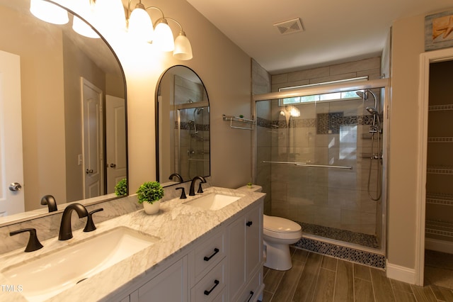 5200 Fieldwood Ct, Raleigh, NC 27616 - bathroom featuring a stall shower, double vanity, and wood tiled floors