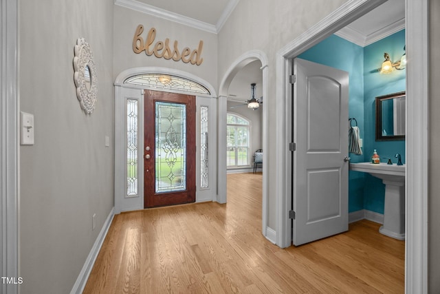 8116 Mosby Way, Willow Springs, NC 27592 - foyer featuring wood finished floors, crown molding, ceiling fan, and arched walkways