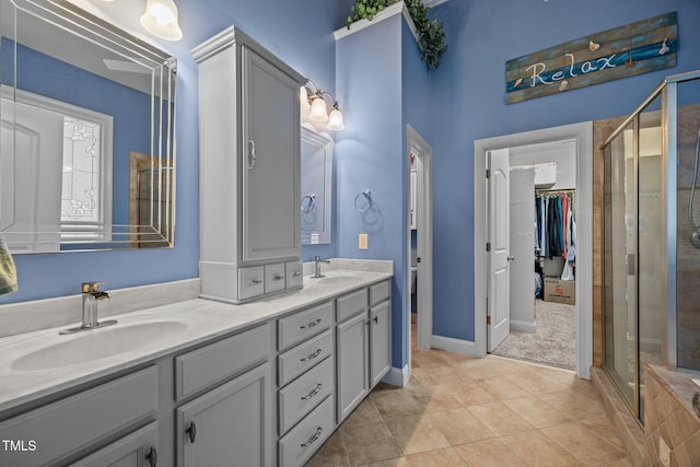 8116 Mosby Way, Willow Springs, NC 27592 - full bath featuring double vanity, a stall shower, tile patterned flooring, and a walk in closet