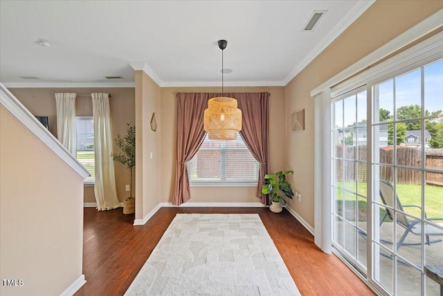 504 Gumview Cir, Fuquay Varina, NC 27526 - dining space featuring plenty of natural light, wood finished floors, and ornamental molding