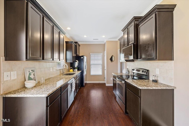 504 Gumview Cir, Fuquay Varina, NC 27526 - kitchen featuring appliances with stainless steel finishes, dark wood-style floors, dark brown cabinetry, ornamental molding, and tasteful backsplash
